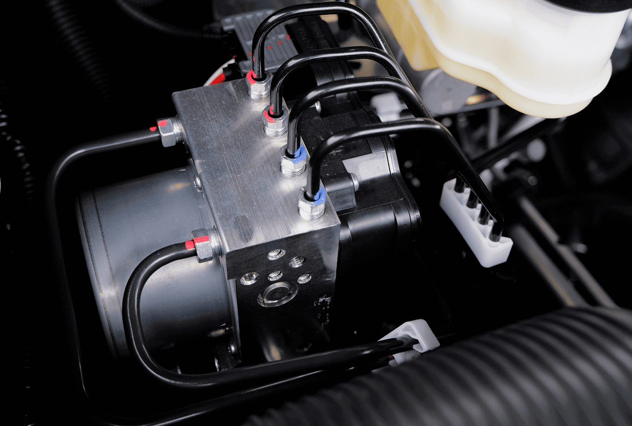 Car engine component with connected cables.