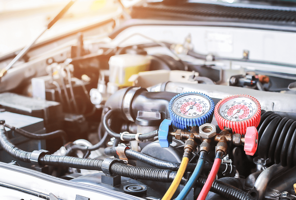 Car engine with air conditioning gauges attached.