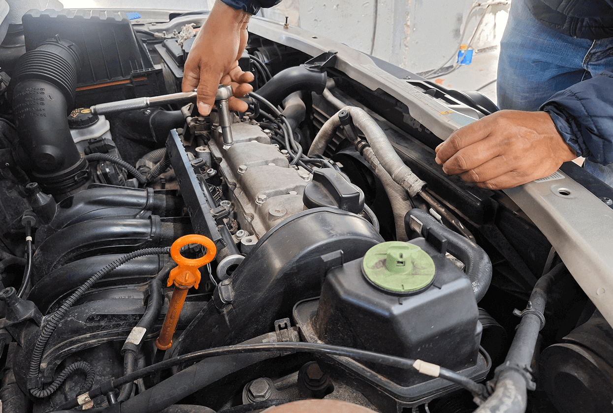 Mechanic working on car engine components.