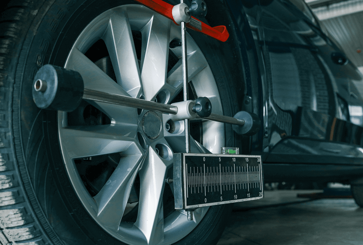 Car wheel alignment equipment in use.