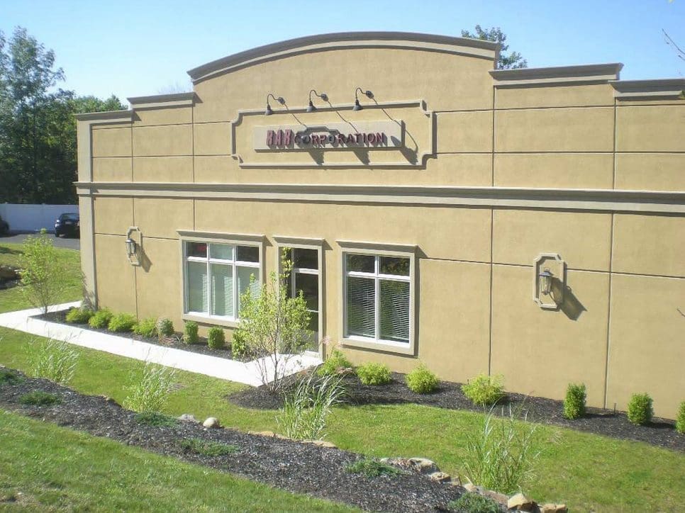 Exterior of a beige building with a sign reading 'Little Caesars'.